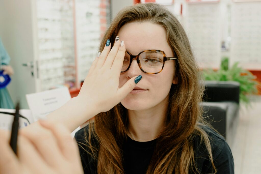 Crop oculist covering eye of woman